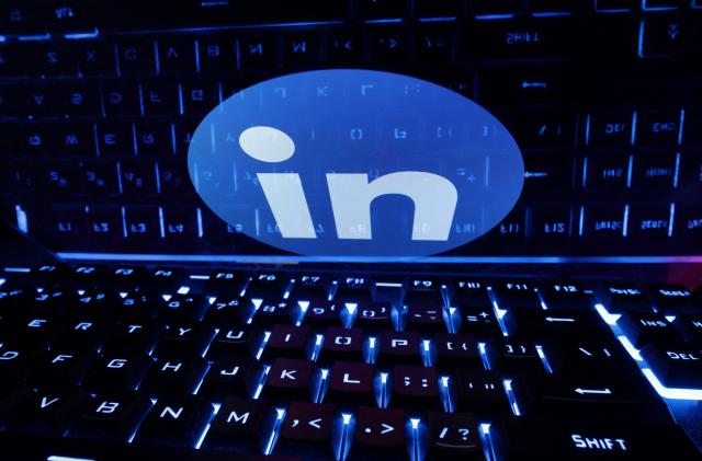 A keyboard is placed in front of a displayed LinkedIn logo in this illustration taken February 21, 2023. REUTERS/Dado Ruvic/Illustration