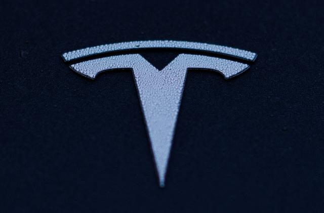 A Tesla logo is shown on a Model 3 vehicle in Encinitas, California, U.S.,October 20, 2023.     REUTERS/Mike Blake